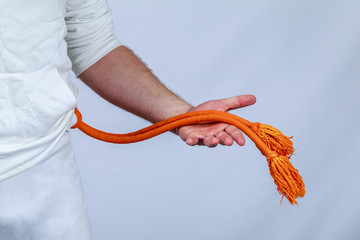 Athlete shows orange belt capoeira