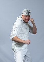 Athlete shows capoeira techniques with bandana on his head