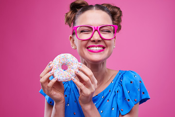 Young overjoyed girl with tasty doughnut