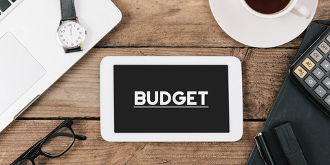 Text budget on screen of table computer at office desk