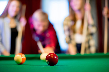 friends playing billiard