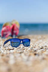 Fototapeta na wymiar Photography of sunglasses on seashore