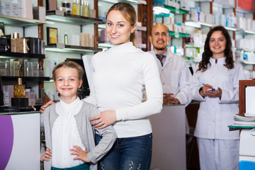 Fototapeta na wymiar Two pharmacists helping customers