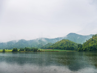 Beautiful tranquil lake and mountain covered with fog