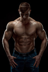 Fototapeta na wymiar Young bodybuilder man on black background