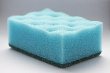 Obraz na płótnie Canvas blue sponge for washing dishes on white background