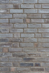 graue vertikale Ziegelsteinwand Textur