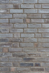 Fototapeta premium graue vertikale Ziegelsteinwand Textur