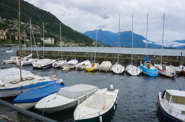 Fototapeta na wymiar Boats at the pier on lake Como Italy
