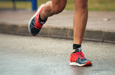 Male athlete running on the street.