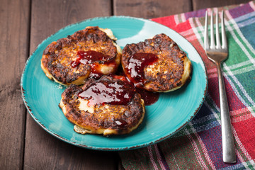 cheese pancake with jam on a plate