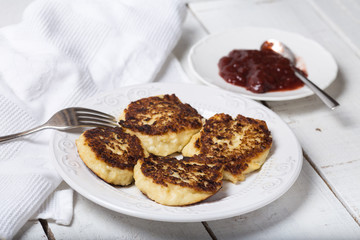 cheese pancake with jam on a plate