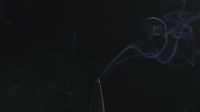 Slow motion of blue mystery smoke of scent cone rising over black background, 180fps prores footage