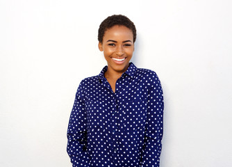 attractive young black woman smiling against isolated white background