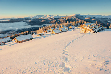 Footprints leading to the chalets in the mountains