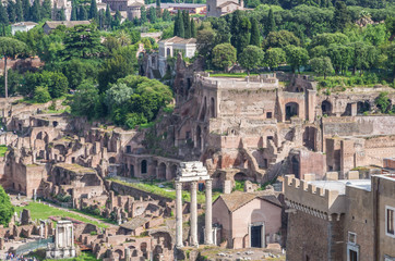 The Roman Forum is a plaza surrounded by many ruins of ancient government buildings in the center of Rome