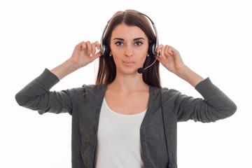 horizontal portrait of young serious call office worker girl with headphones and microphone isolated on white background