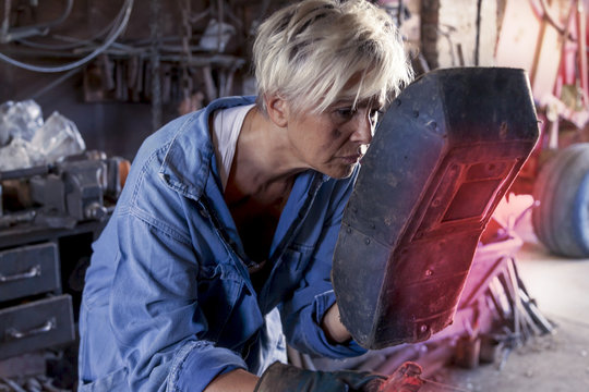beautiful lady at work in his old workshop - Powered by Adobe