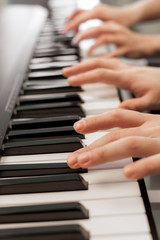 Obraz premium Closeup of hands playing piano. Music and hobby concept