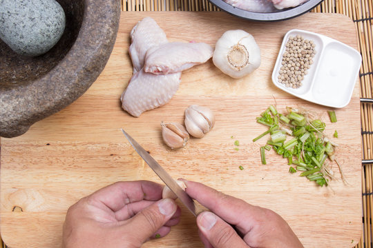 Chef peeling garlic with knife