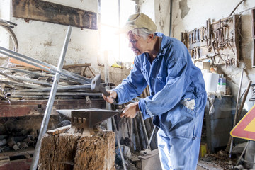 beautiful lady at work in his old workshop