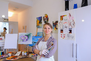 Women beautiful painter posing and smiling, laughing into camera