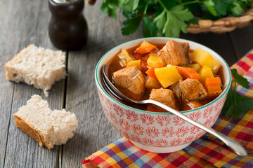 Meat soup estofado with potatoes, carrots and seasonings. Traditional Mexican dishes. Selective focus.