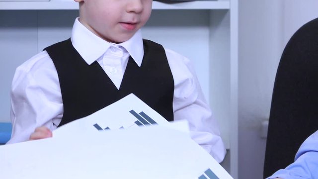 Two boys in the office scatter graphs on steel. Slow motion. Close up
