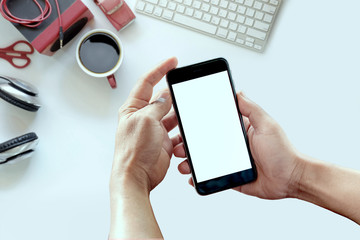 White office desk table with a red gadget . Top view with copy space, flat lay or hero header concept.