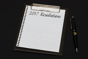 Top view of clipboard and white sheet written with 2017 Resoluti