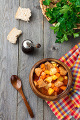 Meat soup estofado with potatoes, carrots and seasonings. Traditional Mexican dishes. Selective focus. Top view.