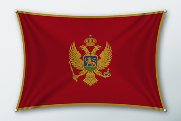 Montenegro national flag. Symbol of the country on a stretched fabric with waves attached with pins. Realistic vector illustration.
