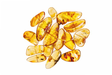 Yellow amber stones on a white background.