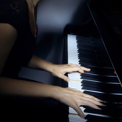 Piano player pianist hands playing grand piano Musical instruments close up