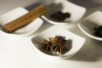 Star anise in a small white bowl