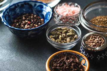 Various spices in a ceramic bowl on slate partial blur