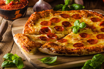 Homemade cheese pizza with salami