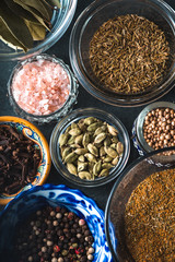 Various spices in a ceramic bowl on slate closeup
