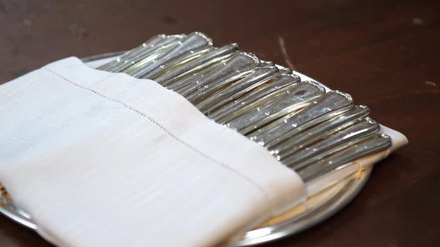 Wedding catering preparation, some forks covered with napkin, 4K