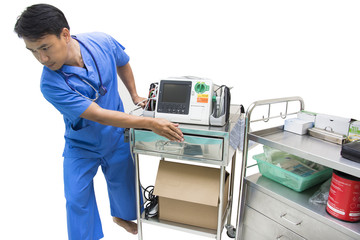 doctor moving defibrillator and AED EKG or ECG monitor