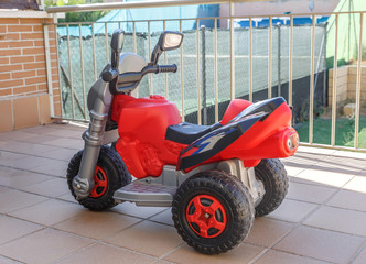 Toy motorcycle on the terrace of a house