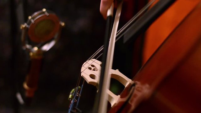 Man playing cello and recording in studio