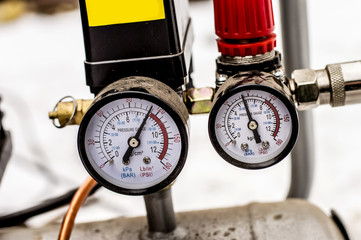 The pressure gauge on the air compressor half full