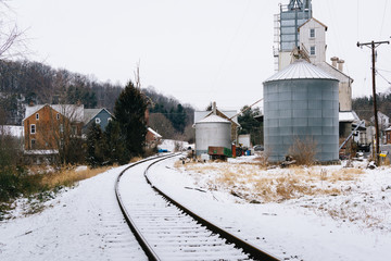 Snow covered railroad tracks and silo, in Lineboro, Maryland.
