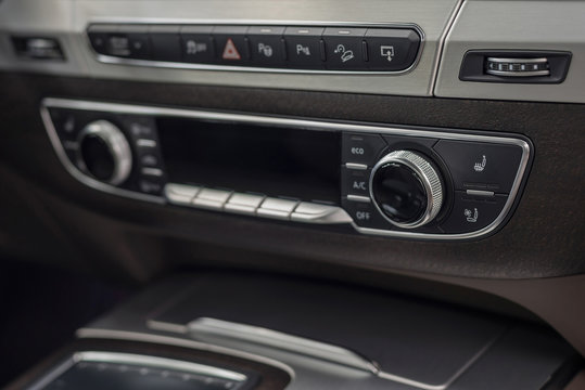 Modern car dashboard with control buttons. Interior detail.