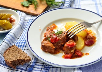 Beef goulash with sauce and potatoes