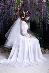 Beauty Portrait of bride wearing in wedding dress with voluminous skirt, studio photo