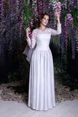 Obraz na płótnie Canvas Beauty Portrait of bride wearing in wedding dress with voluminous skirt, studio photo
