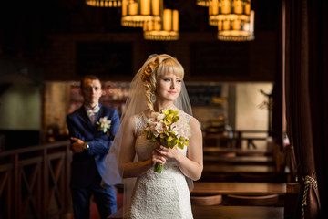 Portrait of beautiful bride on groom background