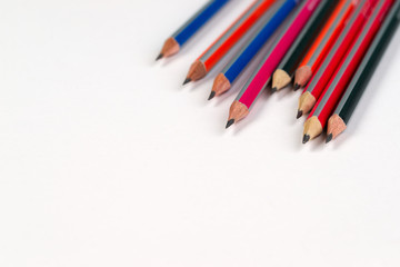 Multicolored pensils on the white paper. Back to school.